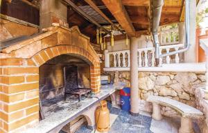 a brick oven in a building with a stone wall at 3 Bedroom Beautiful Apartment In Crikvenica in Crikvenica