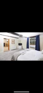 a bedroom with a large bed with blue curtains at The Red Lion in Sedbergh