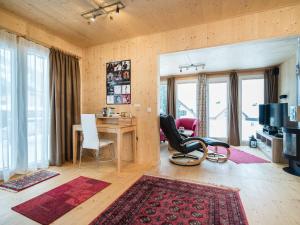 a living room with a desk and a table and chairs at Chalet in Hohentauern with sauna near ski area in Hohentauern