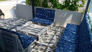two blue and white chairs and a table and chairs at Fanari Stone House in Komotini +4 photos