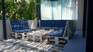 two chairs and a bench on a patio at Fanari Stone House in Komotini