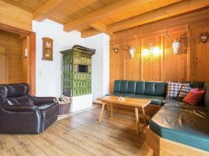 a living room with a couch and a table at Cozy Chalet with Sauna in Gro arl in Grossarl