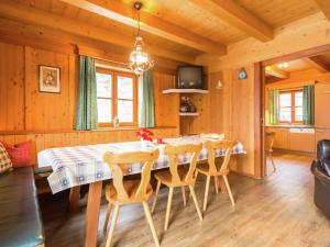 a dining room with a table and chairs at Cozy Chalet with Sauna in Gro arl in Grossarl