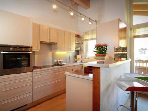 a kitchen with white cabinets and a counter top at Apartment near the ski area in Leogang