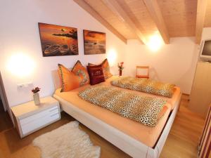 a bedroom with a king sized bed with orange pillows at Apartment near the ski area in Leogang