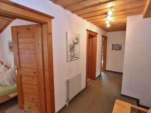 a hallway with a wooden door and a room at Apartment near the ski area in Saalbach Hinterglemm