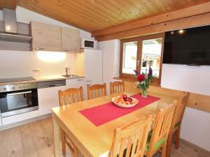 a kitchen and dining room with a table and chairs at Apartment near the ski area in Saalbach Hinterglemm