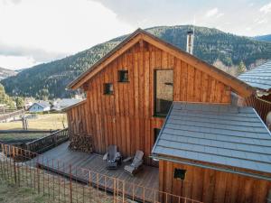 a large wooden cabin with a deck and a roof at Chalet in Stadl an der Mur Styria with sauna in Stadl an der Mur