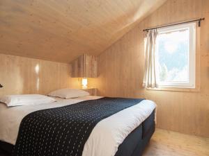 a bedroom with a large bed with a window at Chalet in Stadl an der Mur Styria with sauna in Stadl an der Mur