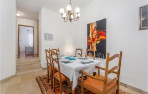 a dining room with a white table and chairs at Nice Apartment In Njivice With Wifi in Njivice