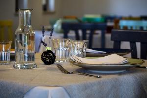 a table with a plate and a bottle and glasses at Agriturismo Villa Cascignoli in Roseto degli Abruzzi