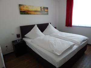 a bedroom with two white pillows on a bed at Ohlenforst Vis a Vis in Wassenberg