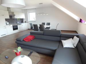 a living room with a couch and a table at Ohlenforst Vis a Vis in Wassenberg +13 photos