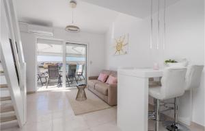 a white living room with a couch and a table at Gorgeous Apartment In Stinica With House Sea View in Stinica