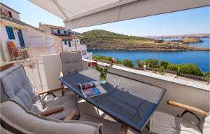 a table and chairs on a balcony with a view of the water at Awesome Apartment In Stinica With 1 Bedrooms And Wifi in Stinica