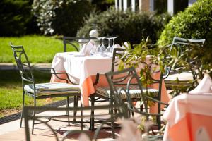 a table with a white table cloth and chairs at Grupotel Playa Club in Son Xoriguer