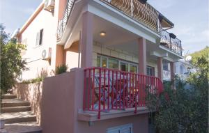 a house with a red railing on a balcony at 3 Bedroom Gorgeous Apartment In Blato in Prizba