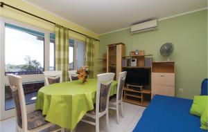a dining room with a table and chairs and a television at 3 Bedroom Gorgeous Apartment In Blato in Prizba
