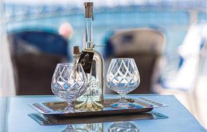 a tray with three wine glasses on a table at Awesome Apartment In Kastel Kambelovac With Wifi in Kaštela