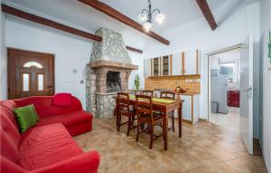 a living room with a red couch and a fireplace at Gorgeous Home In Labin-krsan With Wifi in Kršan