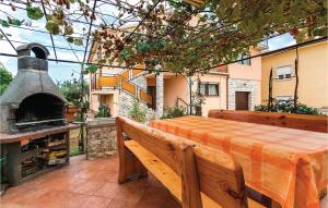 a patio with a table and an outdoor oven at Amazing Apartment In Galizana With Wifi in Galižana