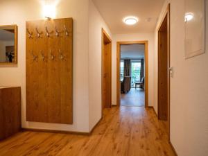 a hallway with wooden doors and wooden floors and a room at Chalet in Bruck Gro glocknerstrasse with sauna in Bruck an der Großglocknerstraße