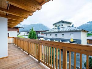 a wooden balcony with a view of a house at Chalet in Bruck Gro glocknerstrasse with sauna in Bruck an der Großglocknerstraße