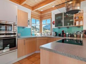 a kitchen with wooden cabinets and a counter top at Country house in St Georgen im Gailtal near Nassfeld in Sankt Georgen im Gailtal