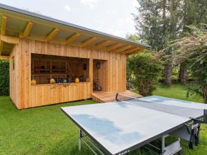 a ping pong table in front of a shed at Bungalow in Gloednitz in Carinthia with pool in Glödnitz