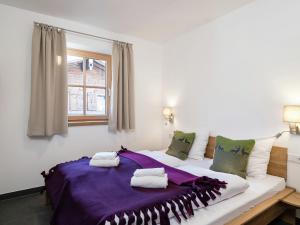 a large white bed in a room with a window at Apartment in Hollersbach with sauna near ski area in Hollersbach im Pinzgau