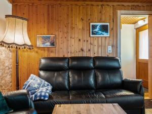 a living room with a leather couch and a table at Holiday home in Eberstein near Woerthersee in Eberstein