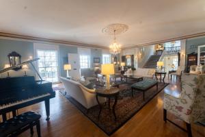 a living room with a piano and a couch at The Morehead Inn in Charlotte