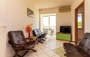 a living room with chairs and a flat screen tv at Beautiful Apartment In Crikvenica With Kitchen in Crikvenica