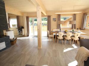 a kitchen and dining room with a table and chairs at Wooden chalet in Hohentauern with sauna in Hohentauern