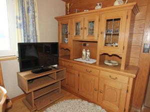 a large wooden entertainment center with a flat screen tv at Home with a wooden decor and full of atmosphere in Außervillgraten