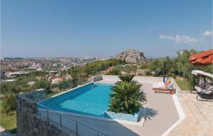 a swimming pool on top of a house at Nice Apartment In Mravince With 2 Bedrooms, Wifi And Outdoor Swimming Pool in Mravince