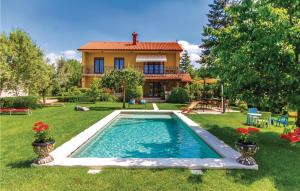 a house with a swimming pool in the yard at Nice Home In Marcana With Kitchen in Marčana