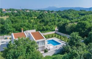 an aerial view of a house with a swimming pool at Stunning Home In Nedescina With Outdoor Swimming Pool in Nedeščina