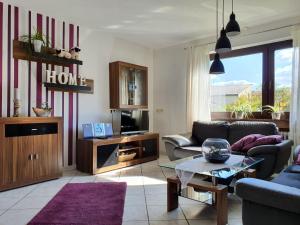 a living room with a couch and a tv at Casa-Maria in Ehrenberg