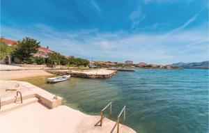 un bateau dans l'eau à côté d'une plage dans l'établissement Cozy Apartment In Kustici With Wifi, à Kustići