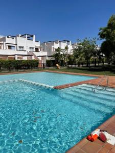 a swimming pool with blue water in front of a building at Casa Beau Murcia, Condado de Alhama in El Romero +29 photos