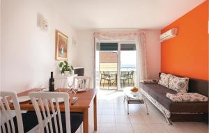 a living room with a couch and a table at Cozy Apartment In Makarska With Kitchen in Makarska