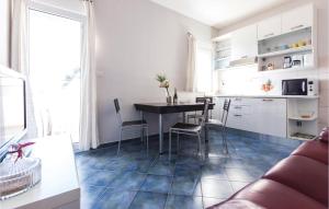a kitchen with a table and chairs in a room at 2 Bedroom Amazing Apartment In Zadar in Zadar