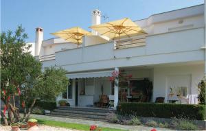 a house with two umbrellas on top of it at 2 Bedroom Amazing Apartment In Zadar in Zadar