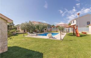 a backyard with a pool and a playground at 2 Bedroom Beautiful Home In Rebici in Rebići