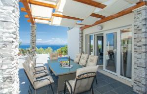 eine Terrasse mit einem Tisch und Stühlen sowie Meerblick in der Unterkunft Amazing Home In Prigradica With 4 Bedrooms And Wifi in Prigradica