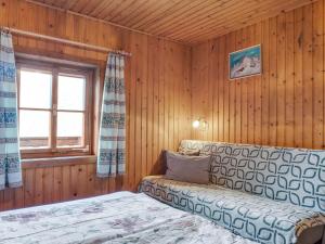 a room with a bed and a window and a couch at Chalet in Moertschach in Carinthia with garden in Mörtschach