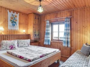 a bedroom with a large bed and a window at Chalet in M rtschach in Carinthia with garden in Mörtschach