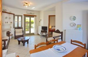 a living room with a table and chairs at To Pithari in Skiros