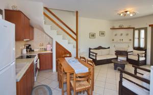 a kitchen and living room with a table and chairs at To Pithari in Skiros